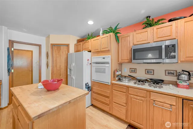 a kitchen with stainless steel appliances a stove microwave and refrigerator