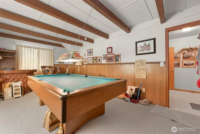 a room with pool table and windows