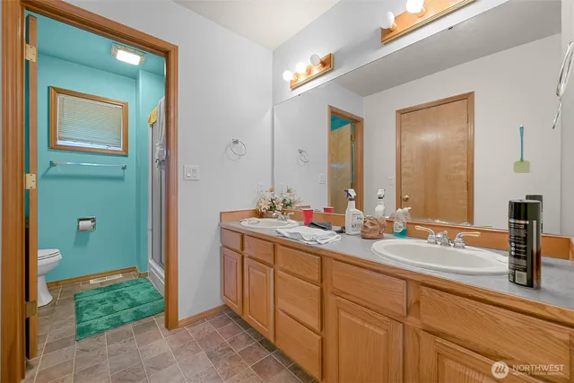 a bathroom with a double vanity sink and a mirror
