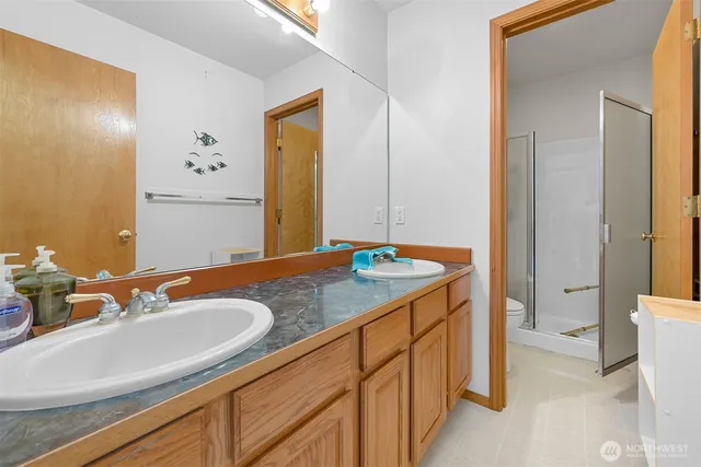 a bathroom with a granite countertop sink and a mirror