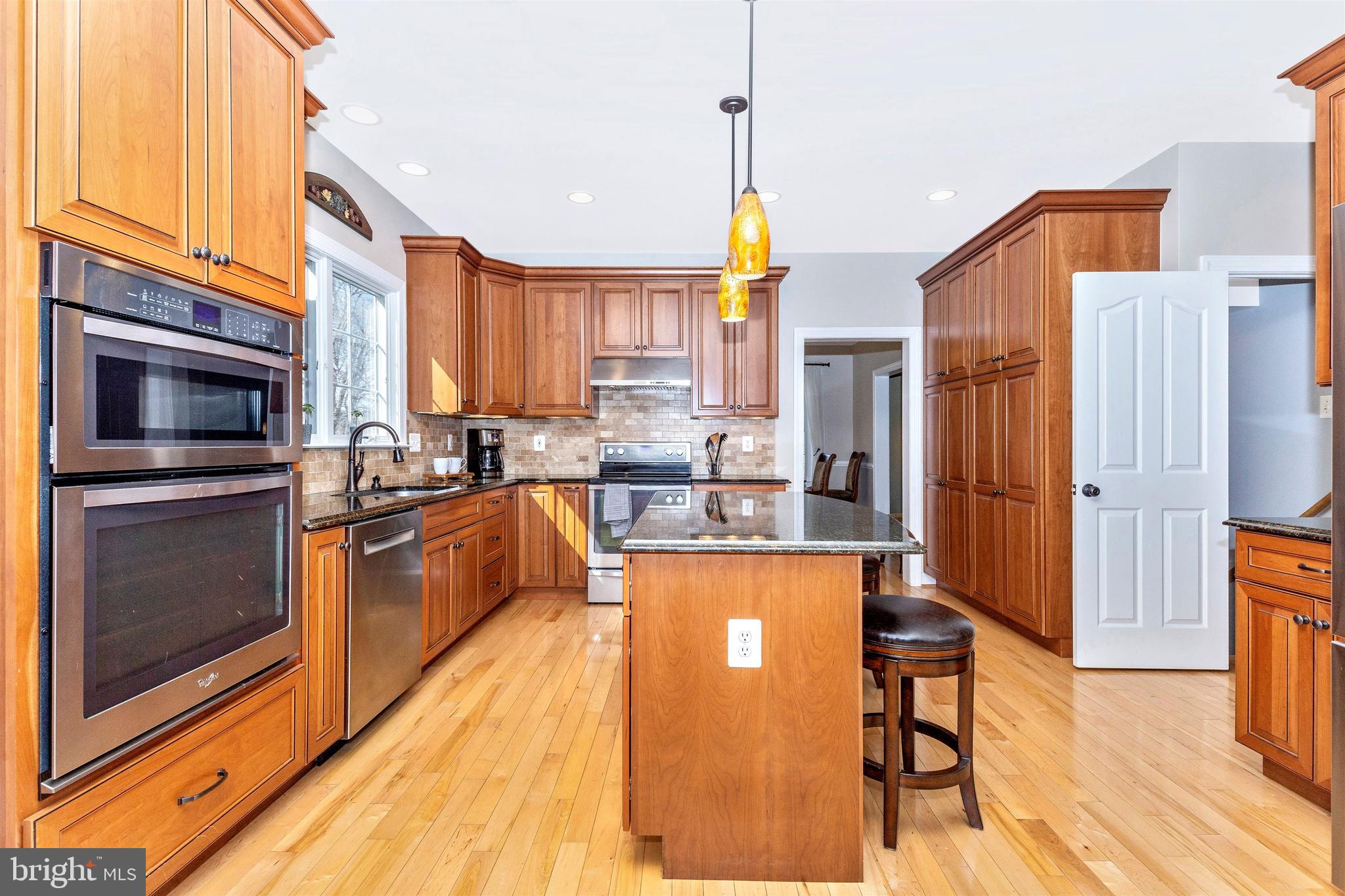 6180 Wimbeldon Drive Mount Airy, MD 21771 - Photo 19 of 63 Island with seating accented with pendant lights