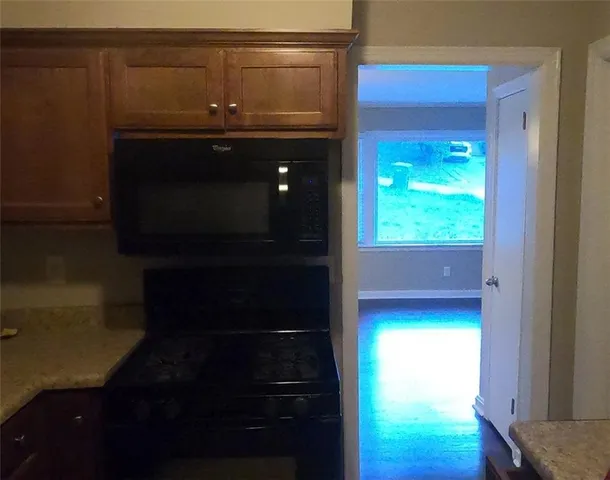 a view of a room with wooden floor and a window