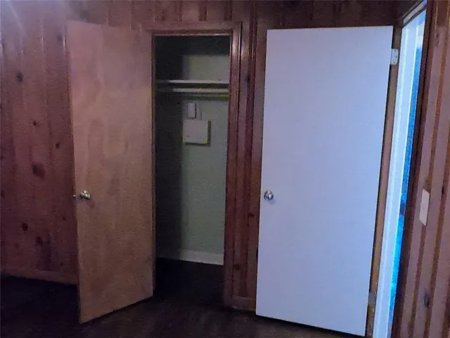 a view of a backyard with a garden and tree