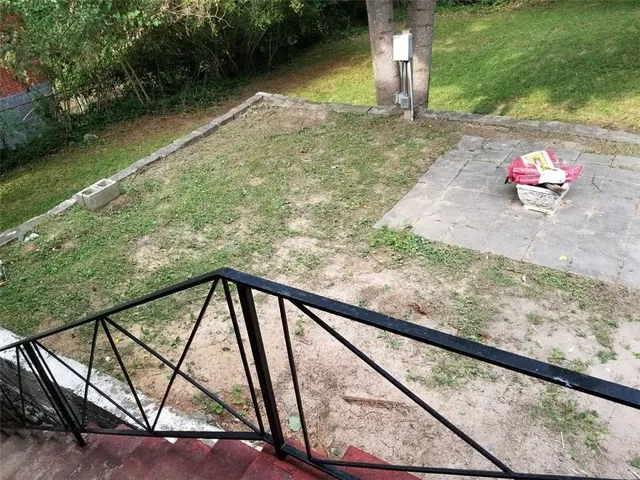 a pathway of a house with a yard