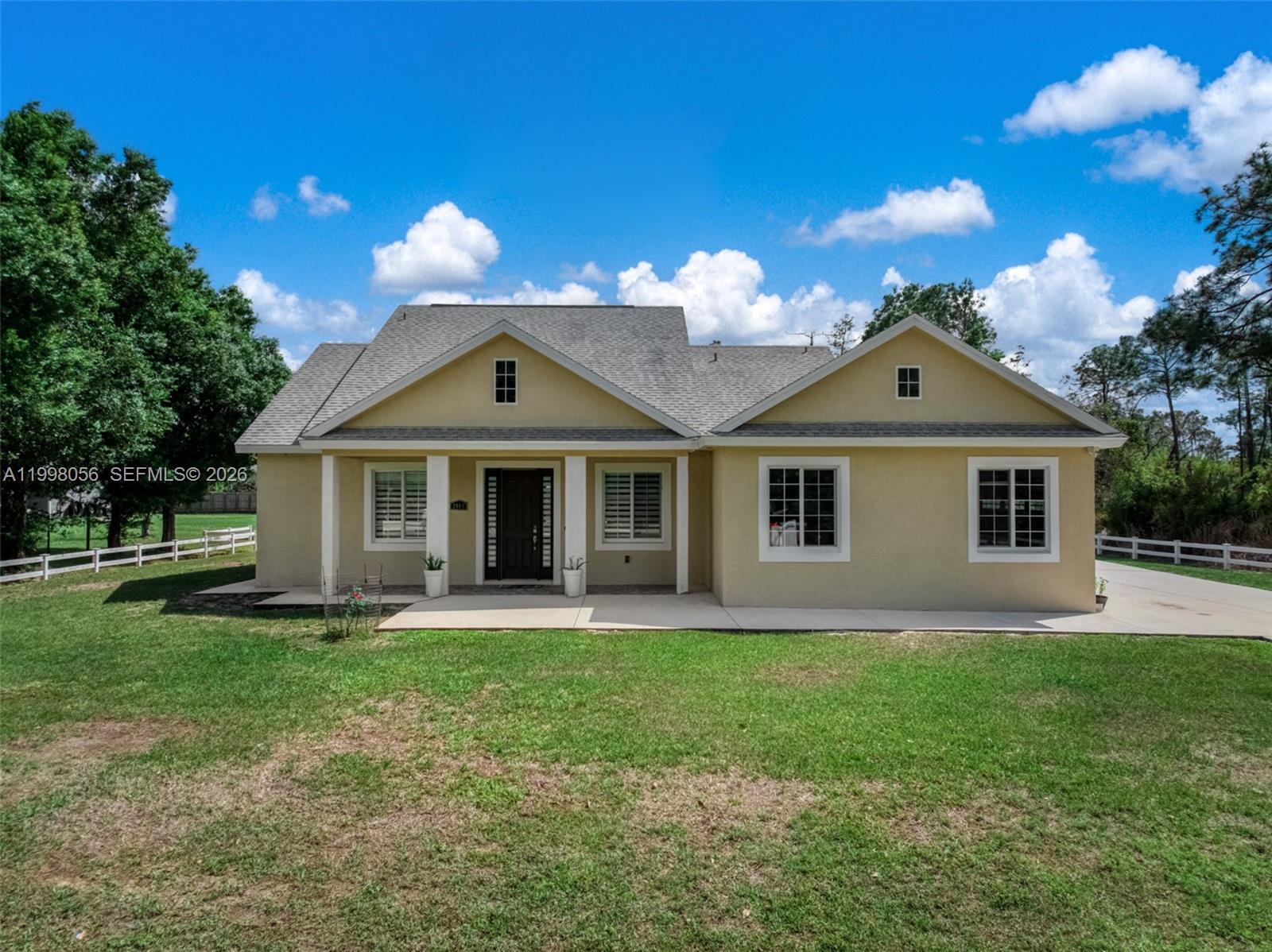 a front view of a house with a yard and porch