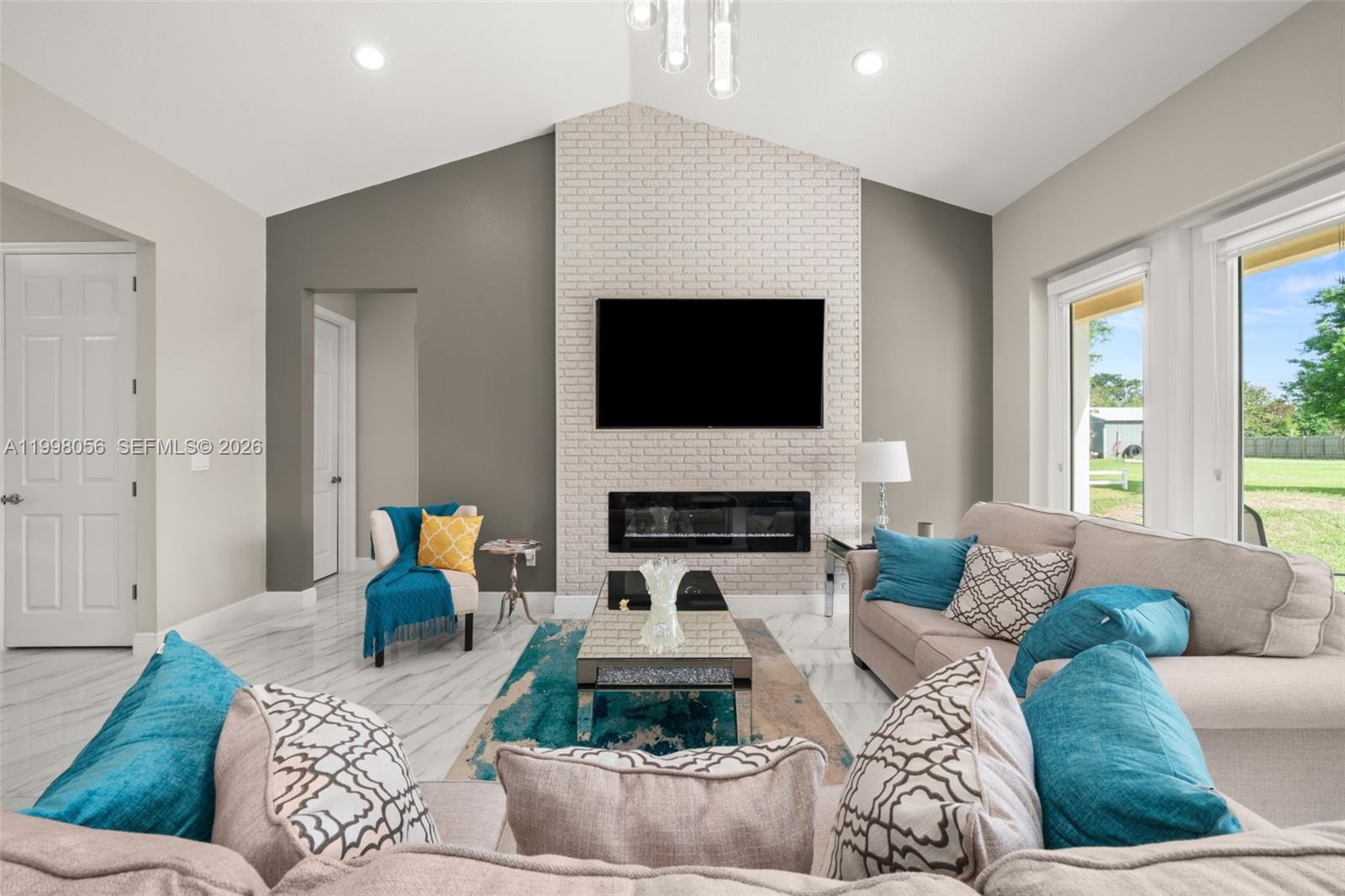 2009 Flower Sebring, FL 33875 - Photo 15 of 61 a living room with furniture a fireplace and a flat screen tv