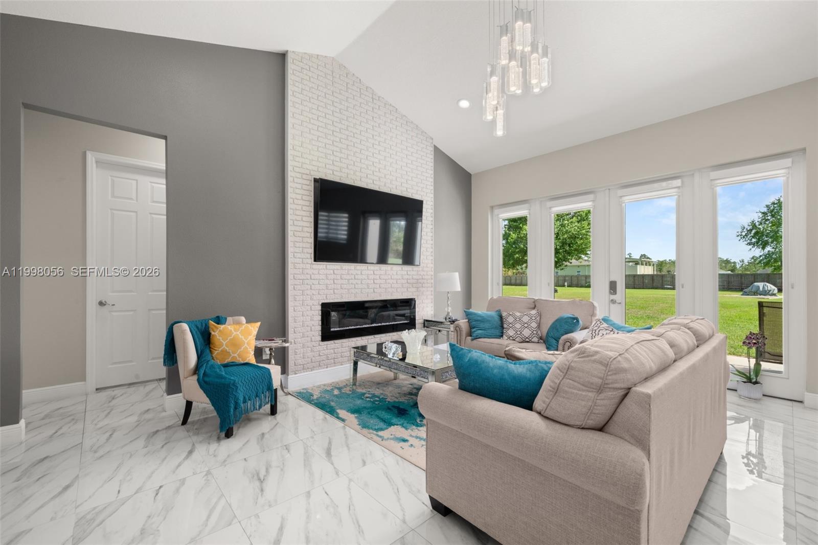 2009 Flower Sebring, FL 33875 - Photo 16 of 61 a living room with furniture a fireplace and a flat screen tv