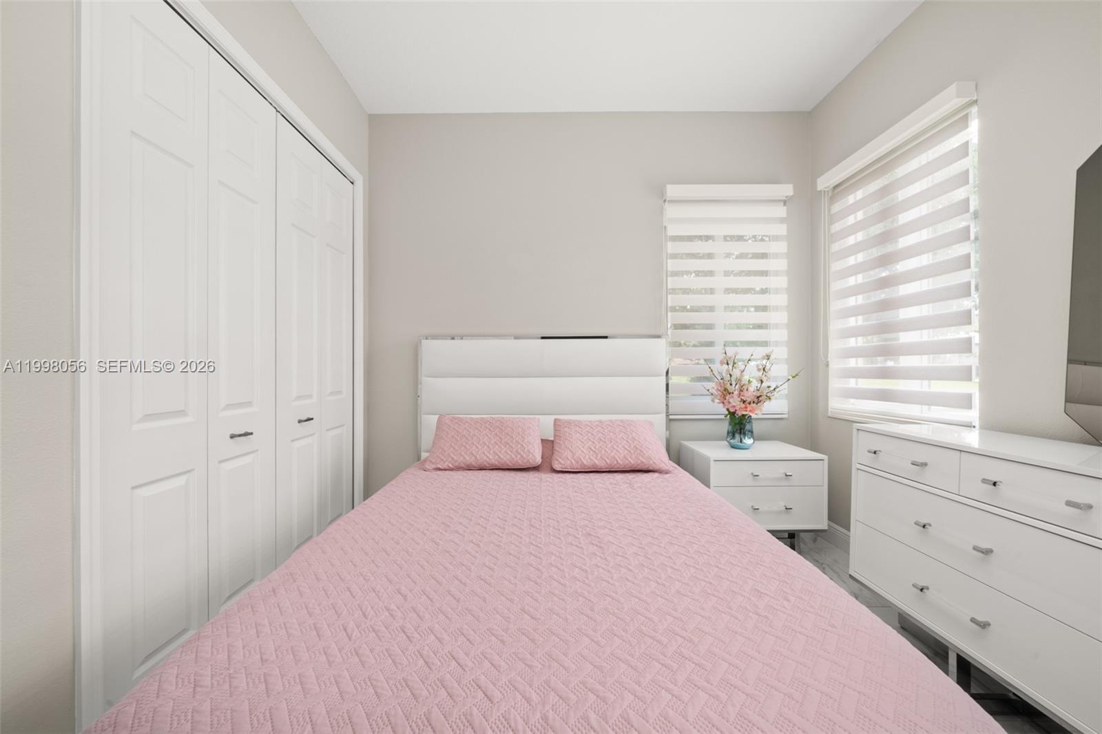 2009 Flower Sebring, FL 33875 - Photo 39 of 61 a bedroom with a large bed and a window