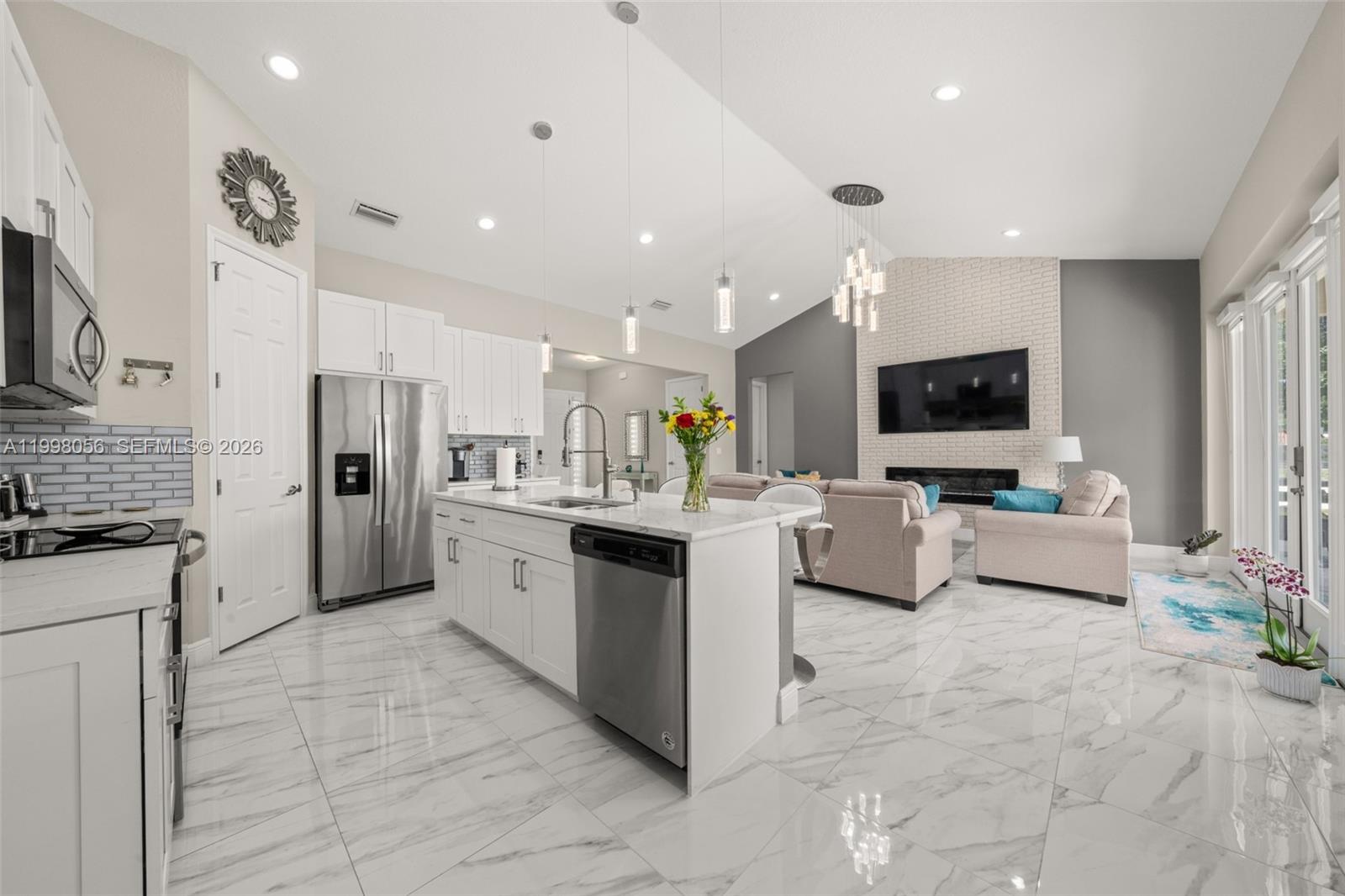 2009 Flower Sebring, FL 33875 - Photo 8 of 61 a large white kitchen with stainless steel appliances kitchen island granite countertop a large counter top stainless steel appliances and cabinets