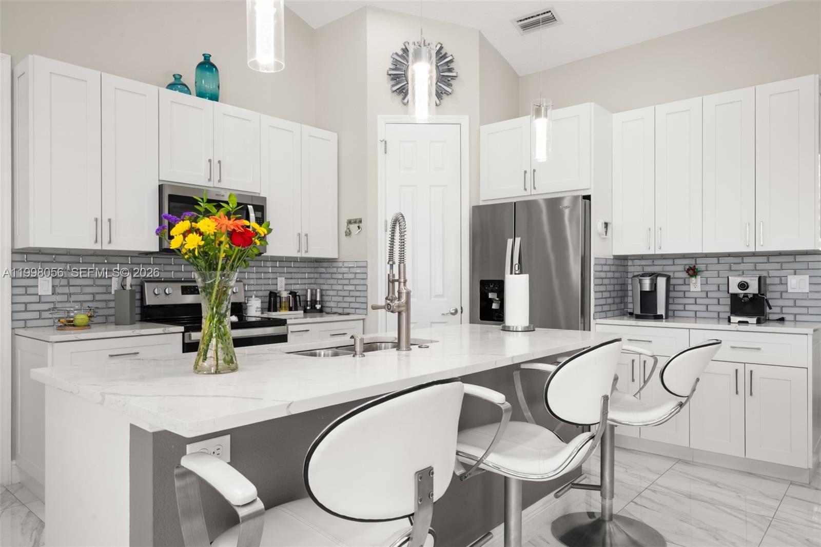 2009 Flower Sebring, FL 33875 - Photo 10 of 61 a kitchen with stainless steel appliances a sink a table and chairs