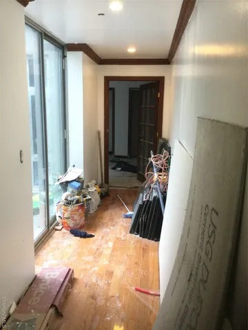 a view of a hallway with furniture and natural light