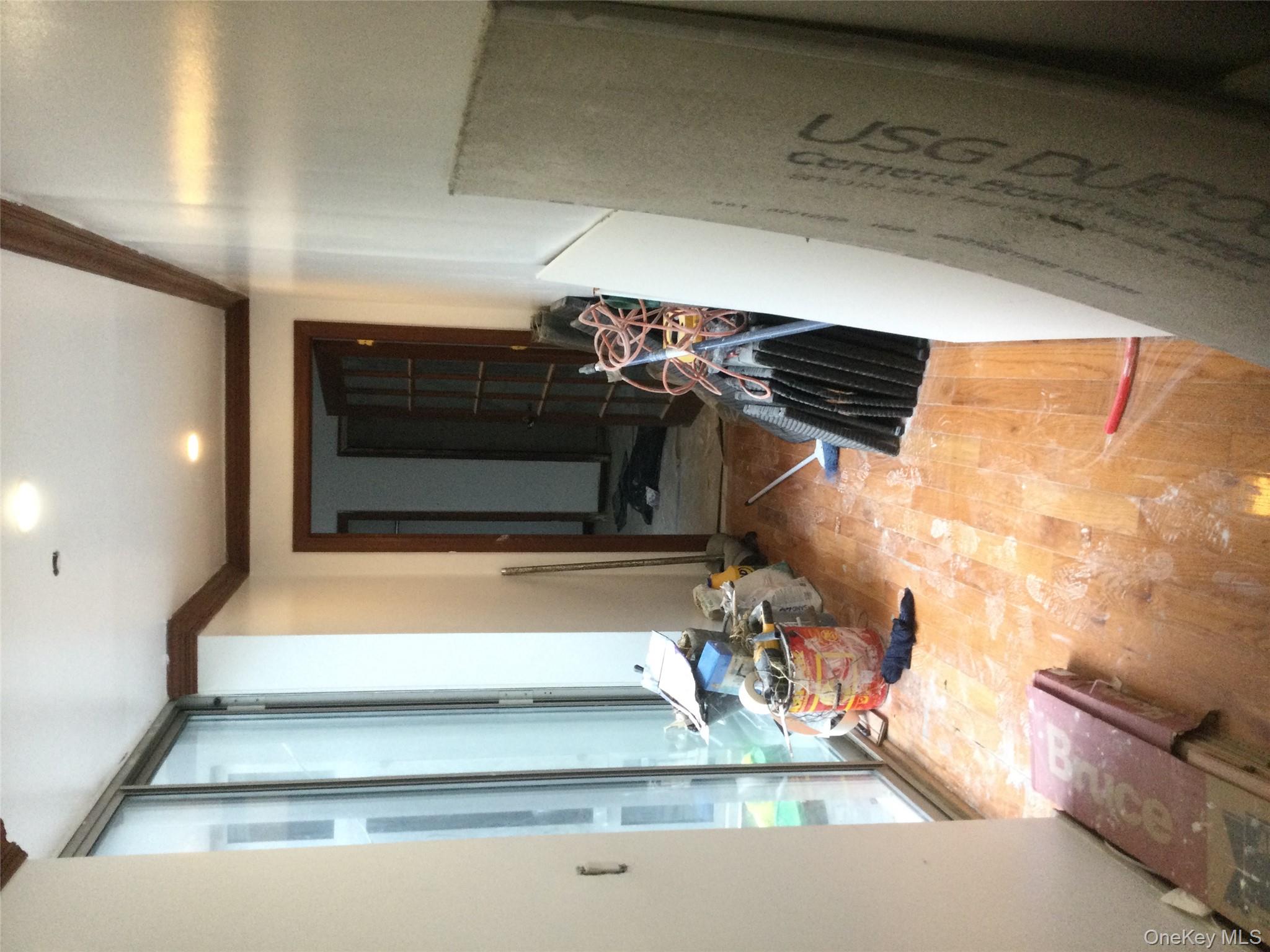 179 Monroe Street, Unit 1A Brooklyn, NY 11216 - Photo 4 of 8 a view of a hallway with furniture and natural light