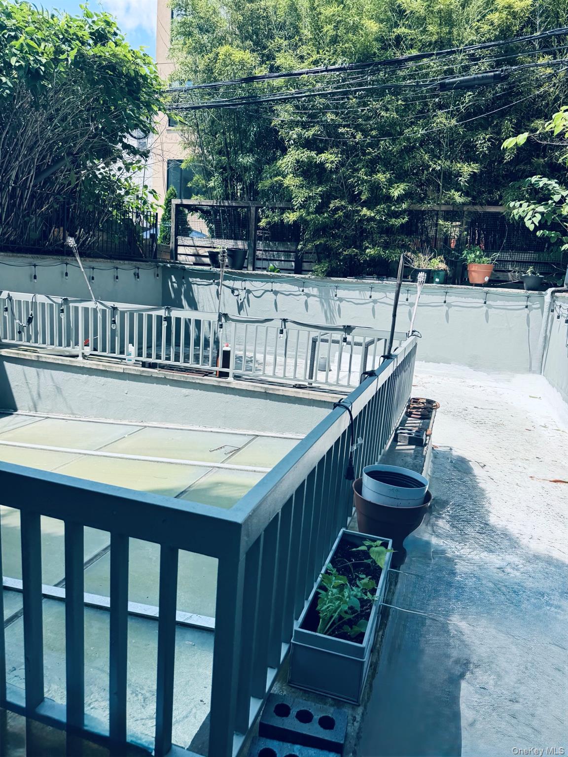 179 Monroe Street, Unit 1A Brooklyn, NY 11216 - Photo 6 of 8 a balcony with table and chairs