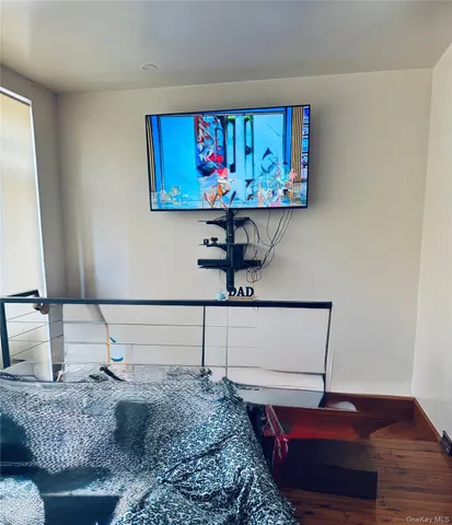 a view of living room with furniture and wooden floor