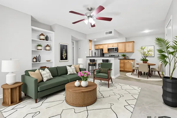 a living room with furniture kitchen view and a chandelier
