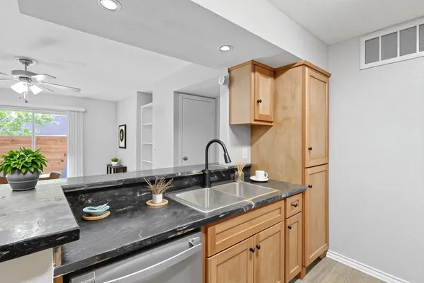 a kitchen with sink and white cabinets