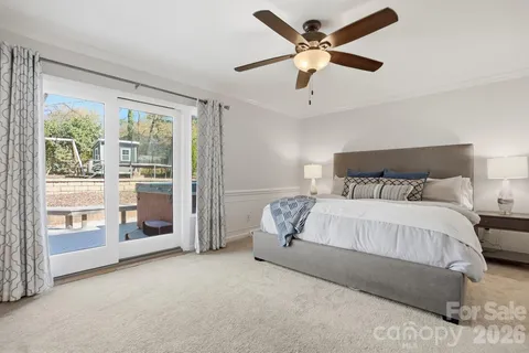 a bedroom with a large bed and a ceiling fan