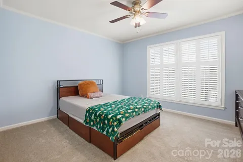 a bedroom with a bed lamp and window