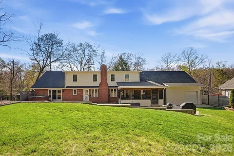 an aerial view of a house with a yard basket ball court and outdoor seating