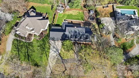 an aerial view of a house with garden space and a street view