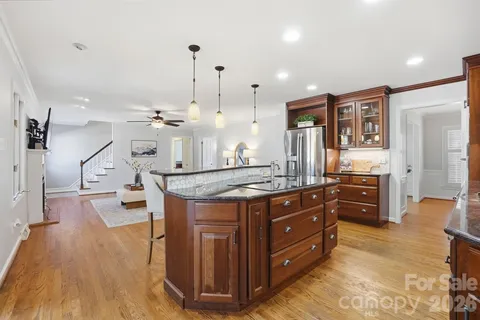 a kitchen with stainless steel appliances granite countertop a stove and cabinets