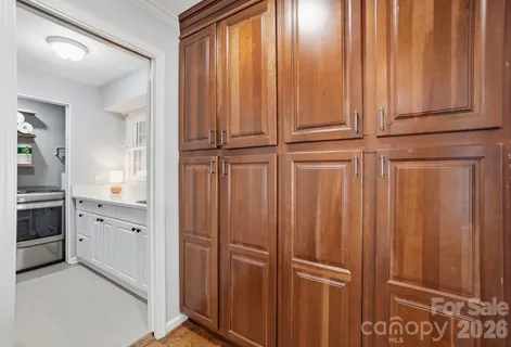 a view of a kitchen with white cabinets