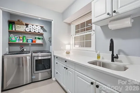 a kitchen with stainless steel appliances granite countertop a sink and a stove