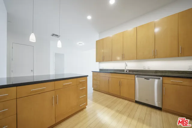 a kitchen with stainless steel appliances granite countertop a sink and cabinets