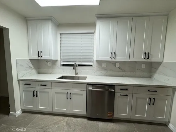 a kitchen with white cabinets