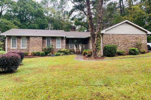 11941 Panhandle Road Hampton, GA 30228 - Photo 1 of 1 a front view of a house with garden