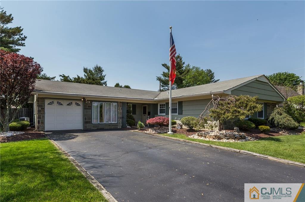 653 Lloyd Road Aberdeen, NJ 07747 - Photo 1 of 18 a front view of a house with garden