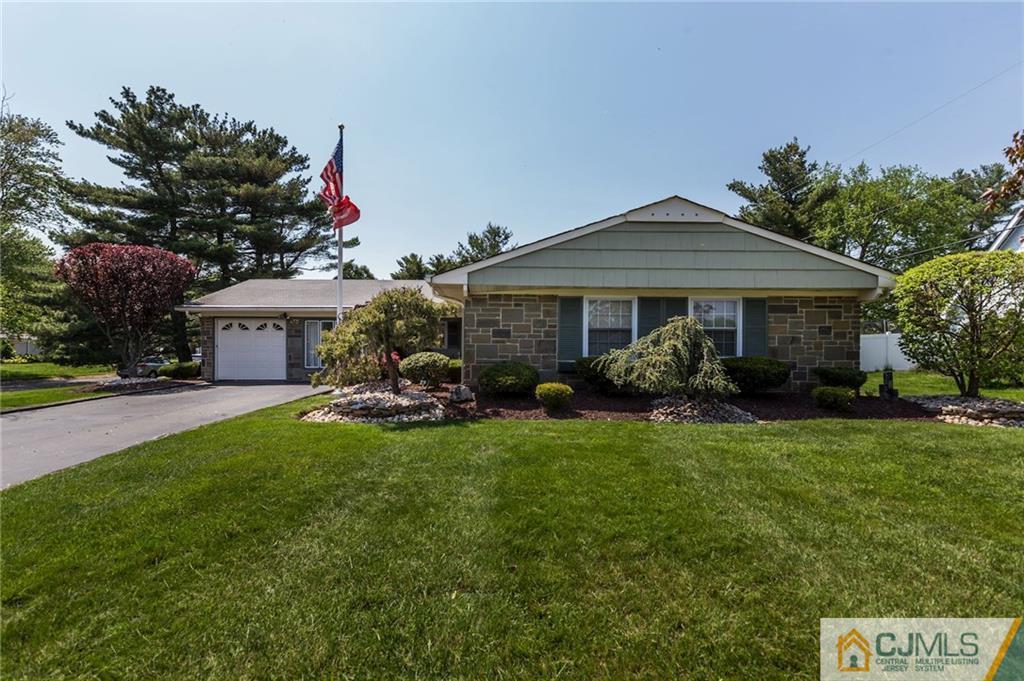 653 Lloyd Road Aberdeen, NJ 07747 - Photo 2 of 18 a front view of a house with garden