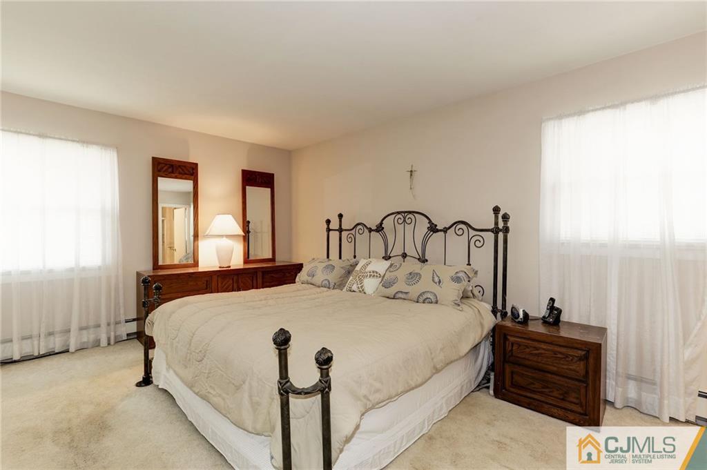 653 Lloyd Road Aberdeen, NJ 07747 - Photo 12 of 18 a bedroom with a bed and window