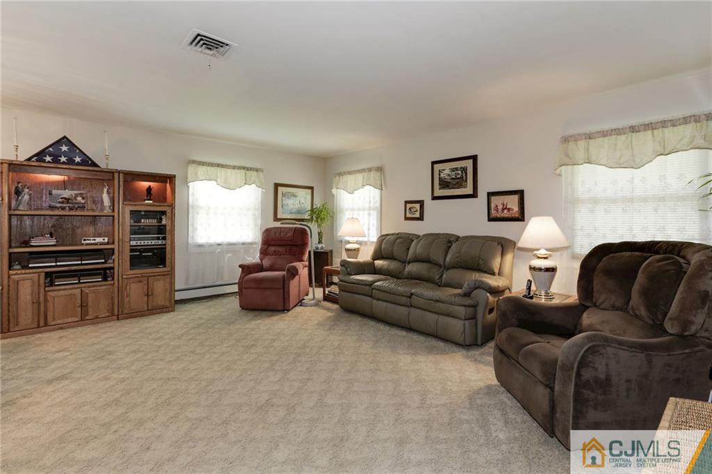 653 Lloyd Road Aberdeen, NJ 07747 - Photo 6 of 18 a living room with furniture and a flat screen tv