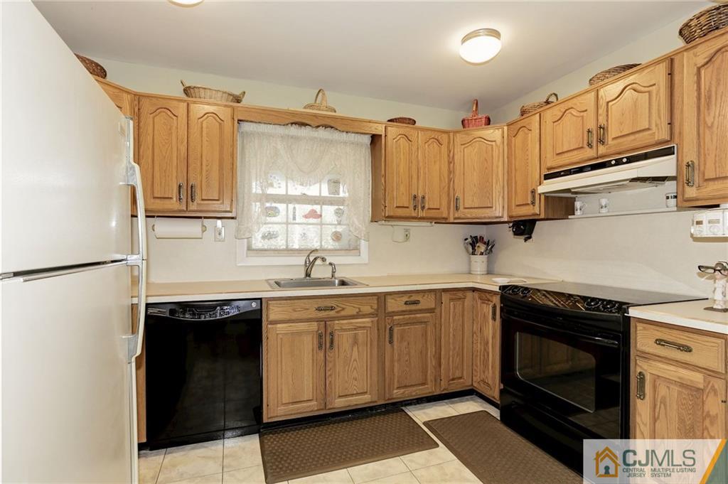 653 Lloyd Road Aberdeen, NJ 07747 - Photo 7 of 18 a kitchen with stainless steel appliances granite countertop a sink stove and refrigerator