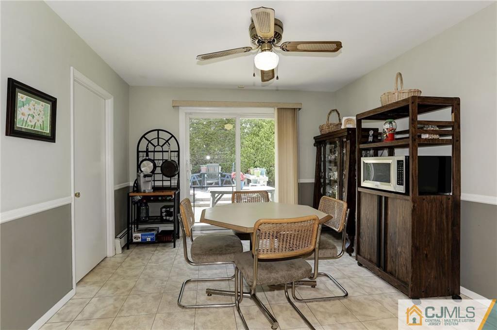 653 Lloyd Road Aberdeen, NJ 07747 - Photo 9 of 18 a dining room with furniture and window