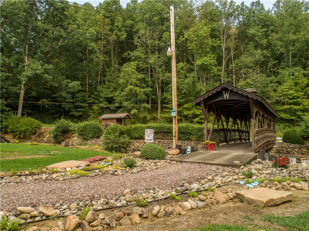 414 Dark Hollow Road Confluence, PA 15424 - Photo 15 of 25 a backyard of a house with barbeque oven table and chairs