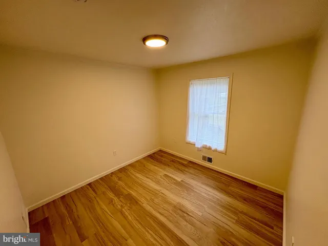 a view of an empty room and wooden floor