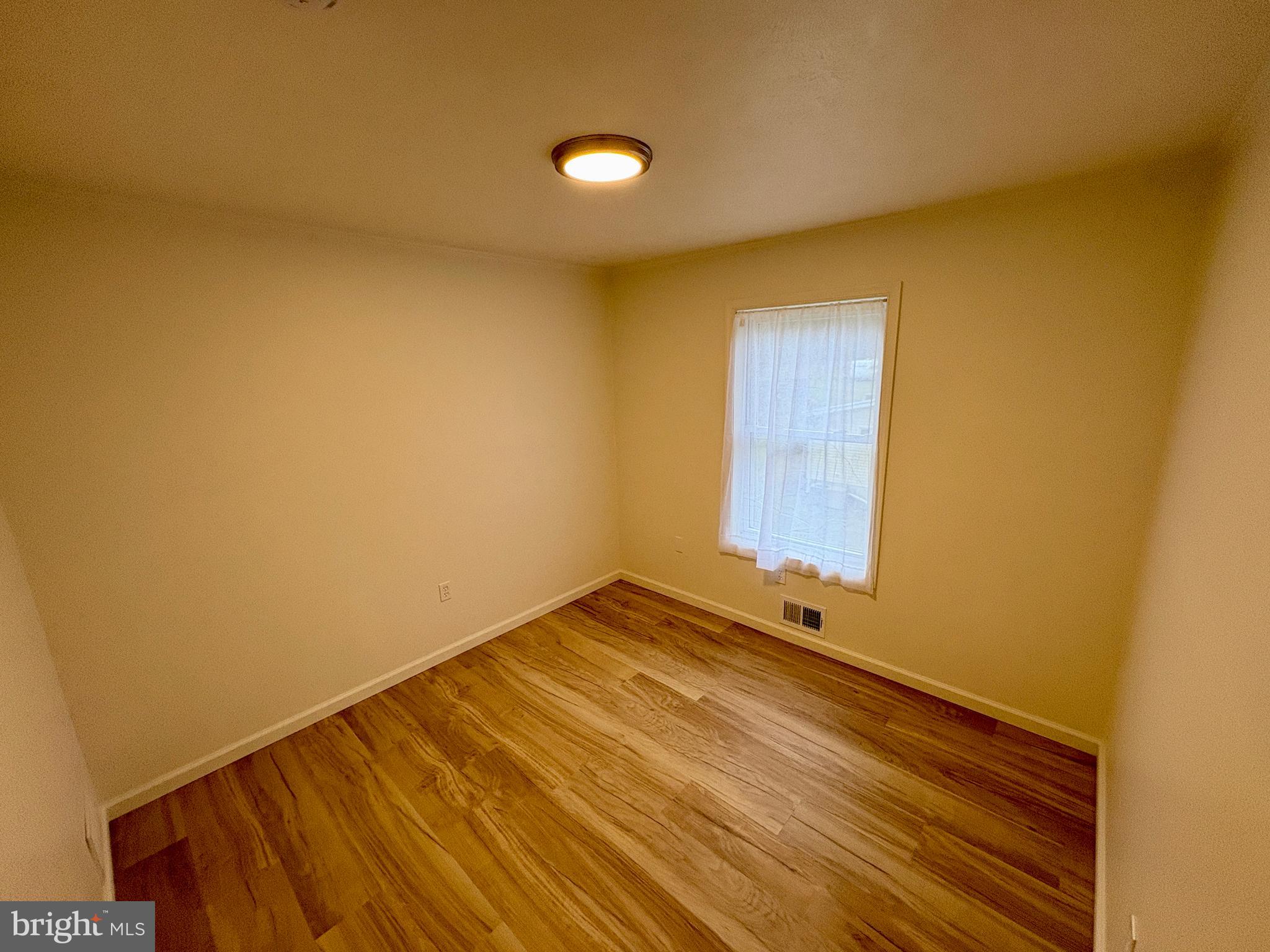 404 Front Street Port Matilda, PA 16870 - Photo 17 of 19 a view of an empty room and wooden floor