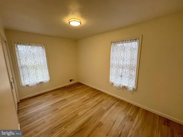a view of room with window and wooden floor