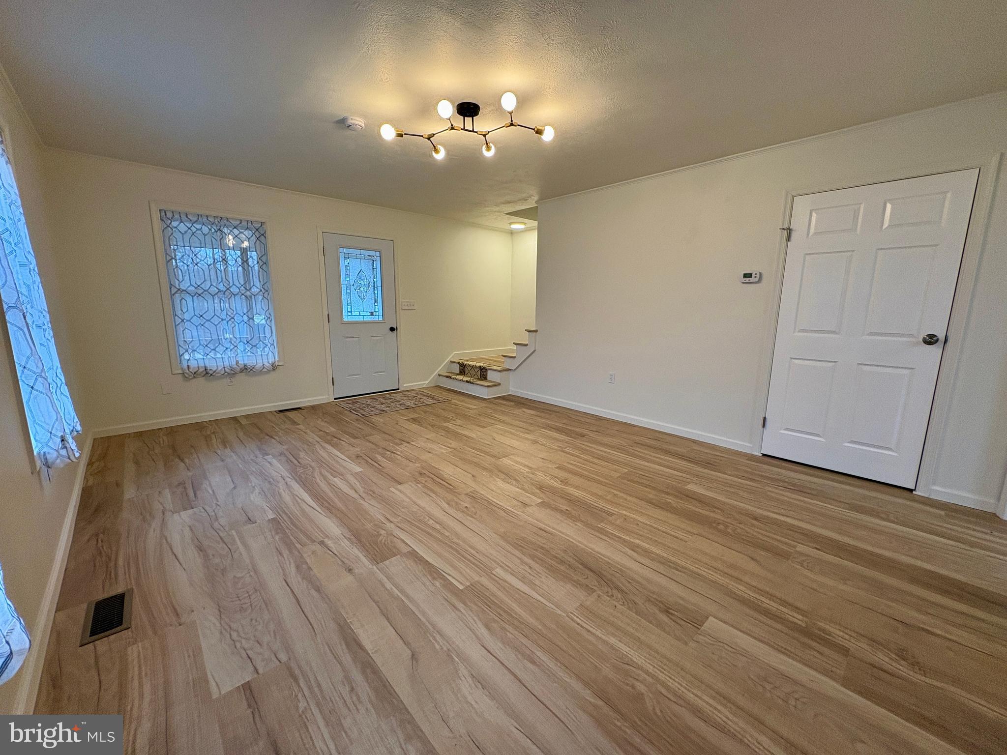 404 Front Street Port Matilda, PA 16870 - Photo 5 of 19 wooden floor in an empty room with a window