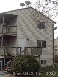 a view of house with balcony and outdoor space