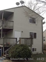 a view of house with balcony and outdoor space