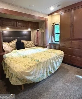 a bed sitting in a bedroom next to a window
