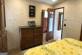 a bedroom with a bed and a mirror