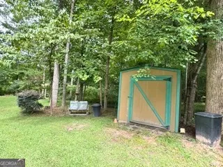 a backyard of a house with a table and chairs