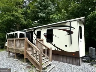 a view of a house with wooden deck