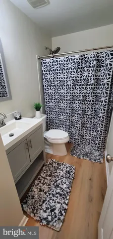 a bathroom with a sink a toilet and a shower