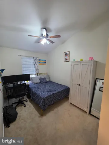 a bedroom with a bed dresser and a window