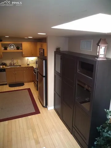 a view of a kitchen with a refrigerator and a ceiling fan